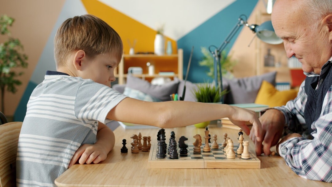 Two senior men playing chess at a wooden table