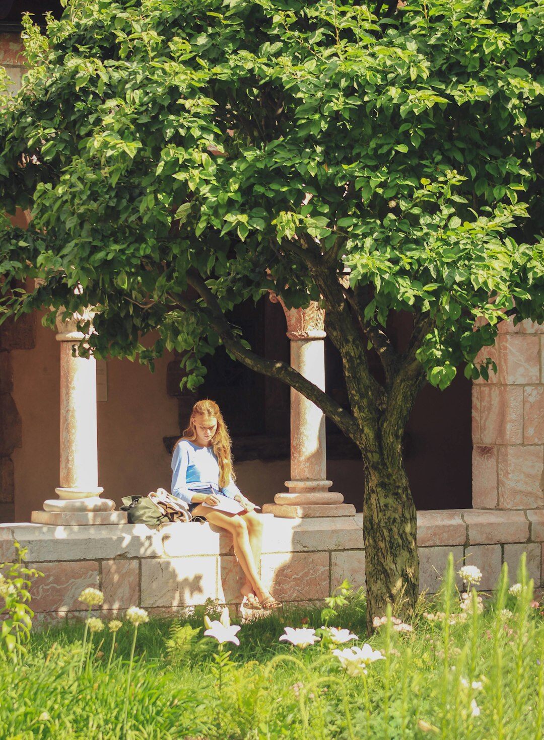 senior woman reading book in garden