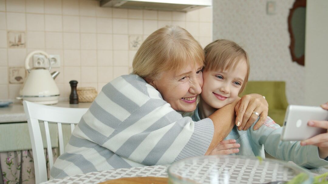 Adult daughter visiting her elderly mother at home